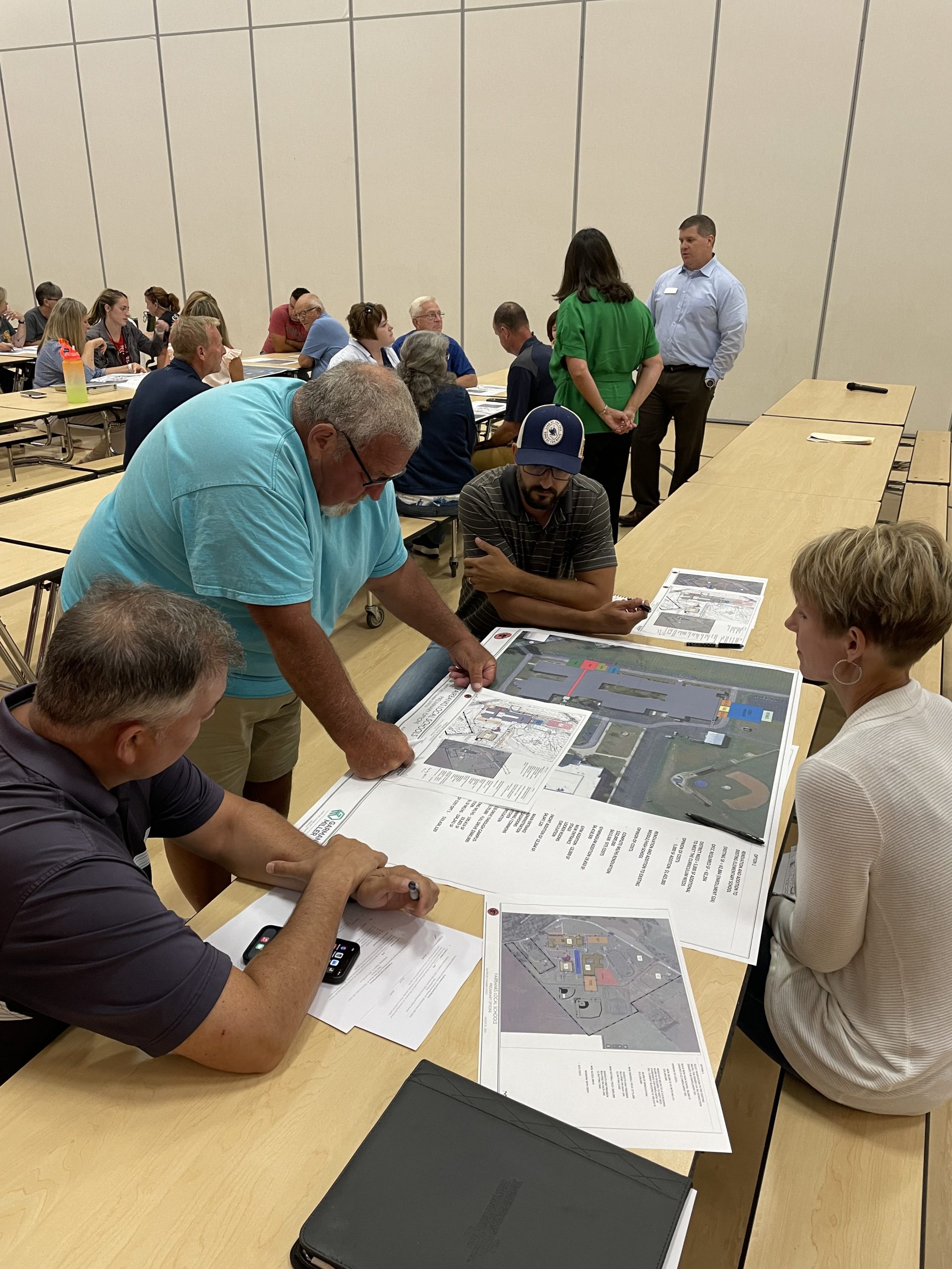 People gathered around table for community meeting with Garmann Miller and Fairbanks Local Schools