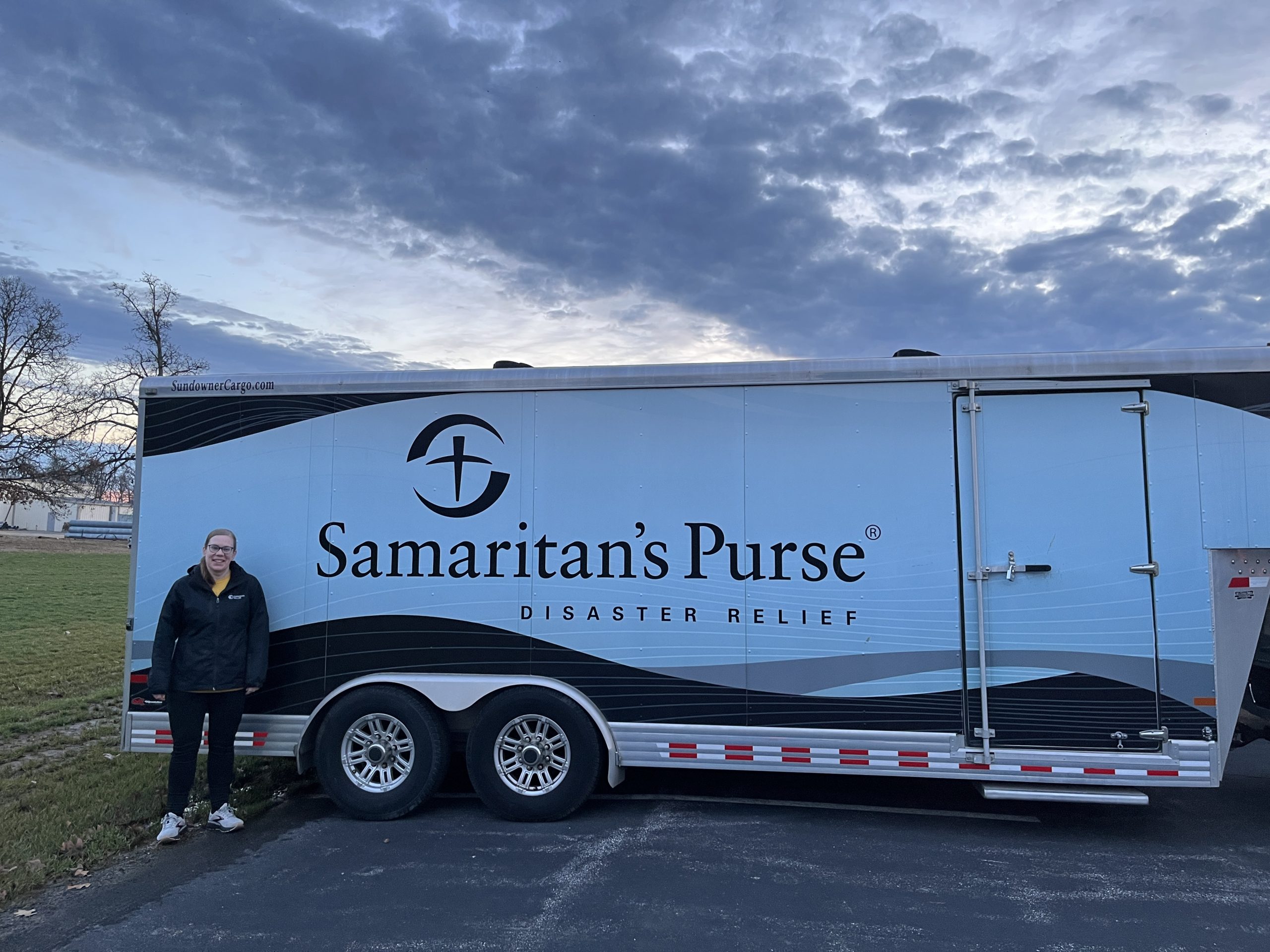 Garmann Miller Team Member Katie Yinger standing in front of volunteer truck