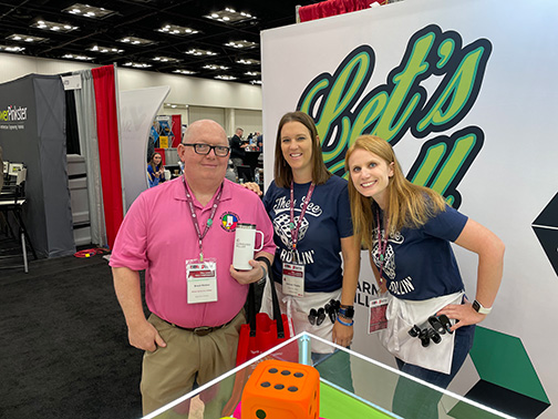 Garmann Miller team at trade show posing with winner