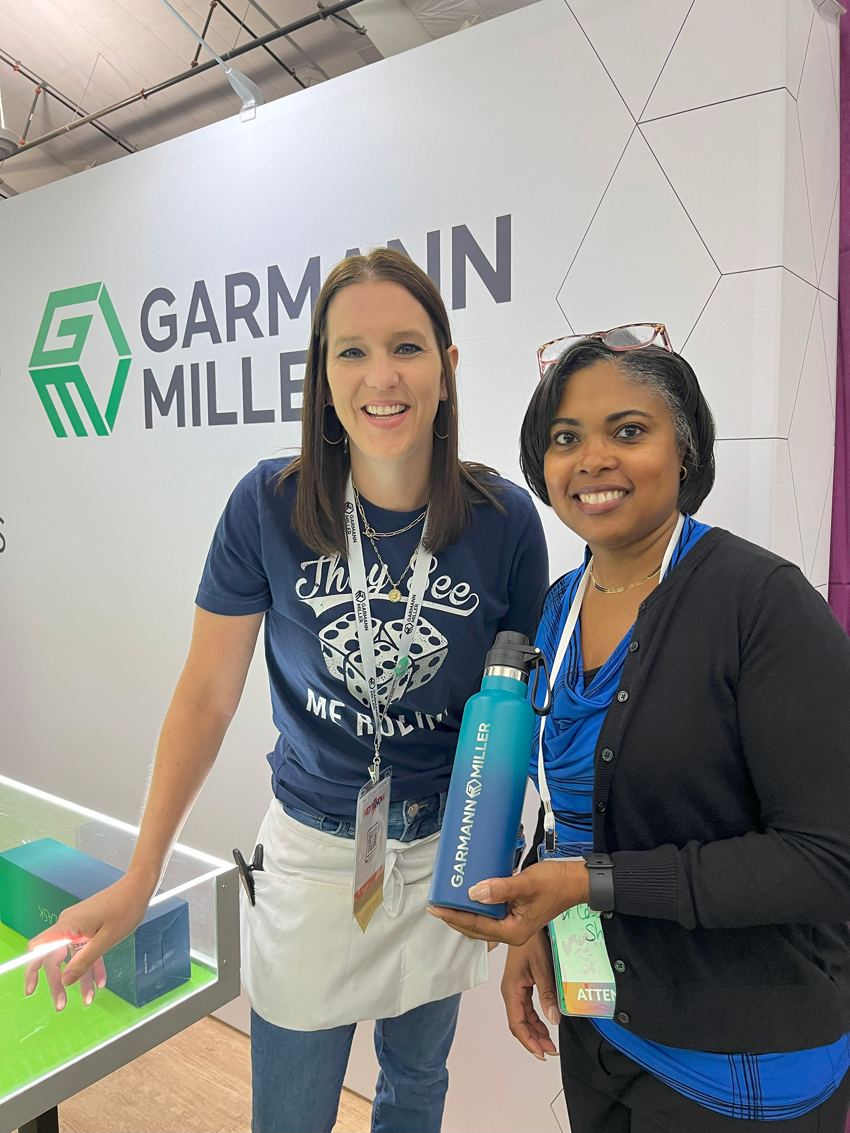 Garmann Miller team member at trade show posing with winner